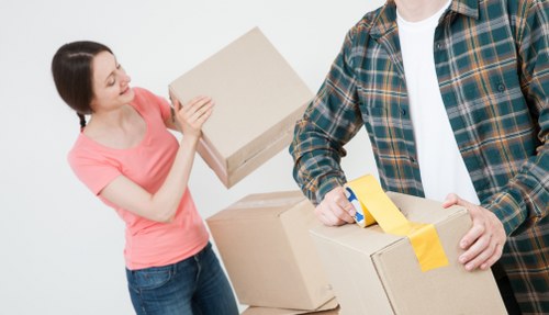 Local removals crew handling household items in East London