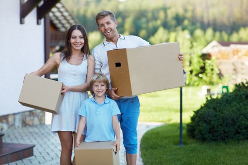 Movers carrying furniture down stairs in a Shoreditch property
