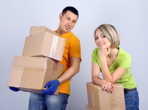 Professional movers carrying items through a Shoreditch apartment entrance