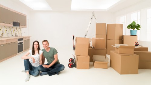 Staff wearing PPE while loading furniture into a van